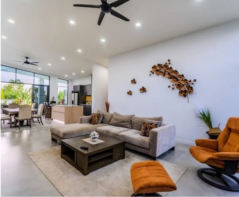 Open-plan living and dining area of a Moda villa with full-height glazing