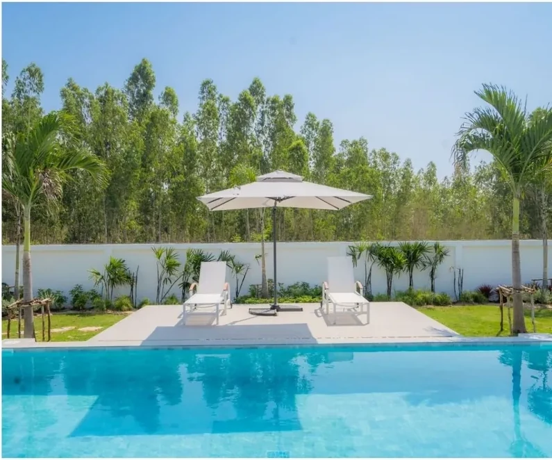 Private pool, sun loungers and landscaped garden at a Moda villa